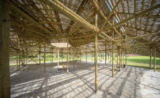 Interior of an outdoor pavilion which is made of bamboo.