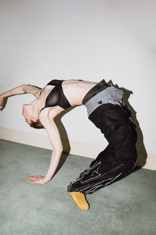 Photography portfolio, titled ‘The Artist is Incognito’, captures a faceless model doing a yoga poses on a green carpet wearing three pairs of trousers, a black bra and yellow socks