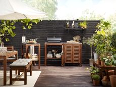 wooden, decked outdoor kitchen and dining area by ikea