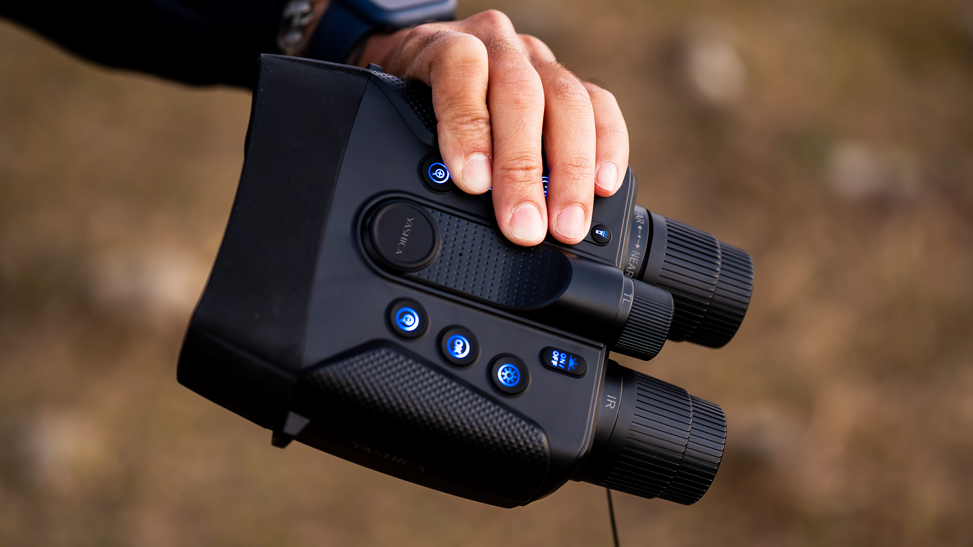 Hold Yashica Night Vision 4K binoculars in your hand, the button lights up