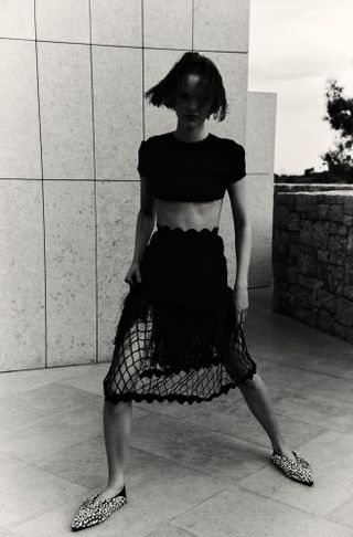 Woman in black skirt and top