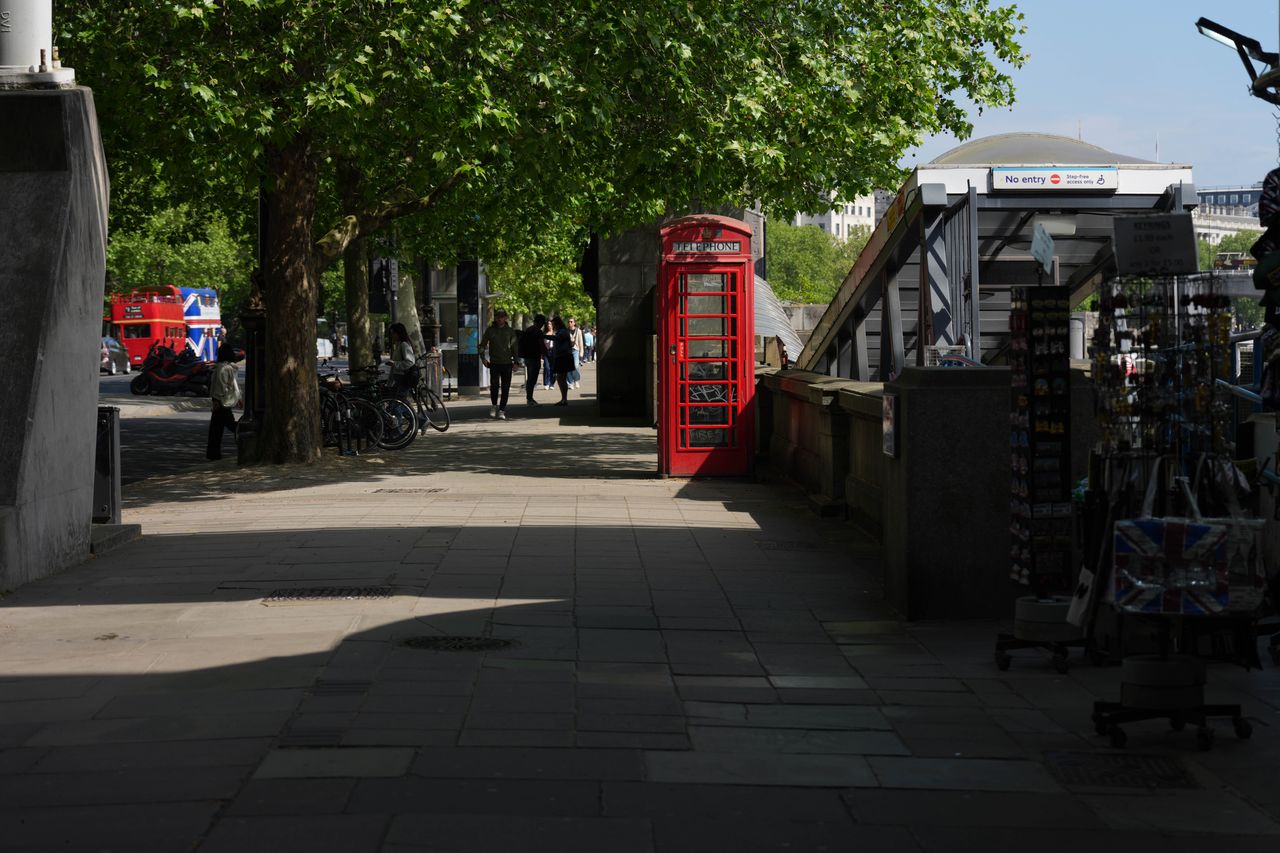 Red telephone box near Westminster Bridge and a no-entry station entrance.