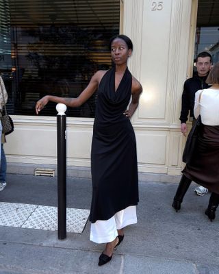 Sylvie Mus wearing a black halter maxi dress in Paris.