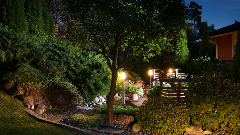 The best Philips Hue outdoor lighting: Image depicts garden being illuminated by Philips Hue lighting