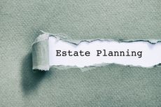 Estate planning written under torn paper on a light green background