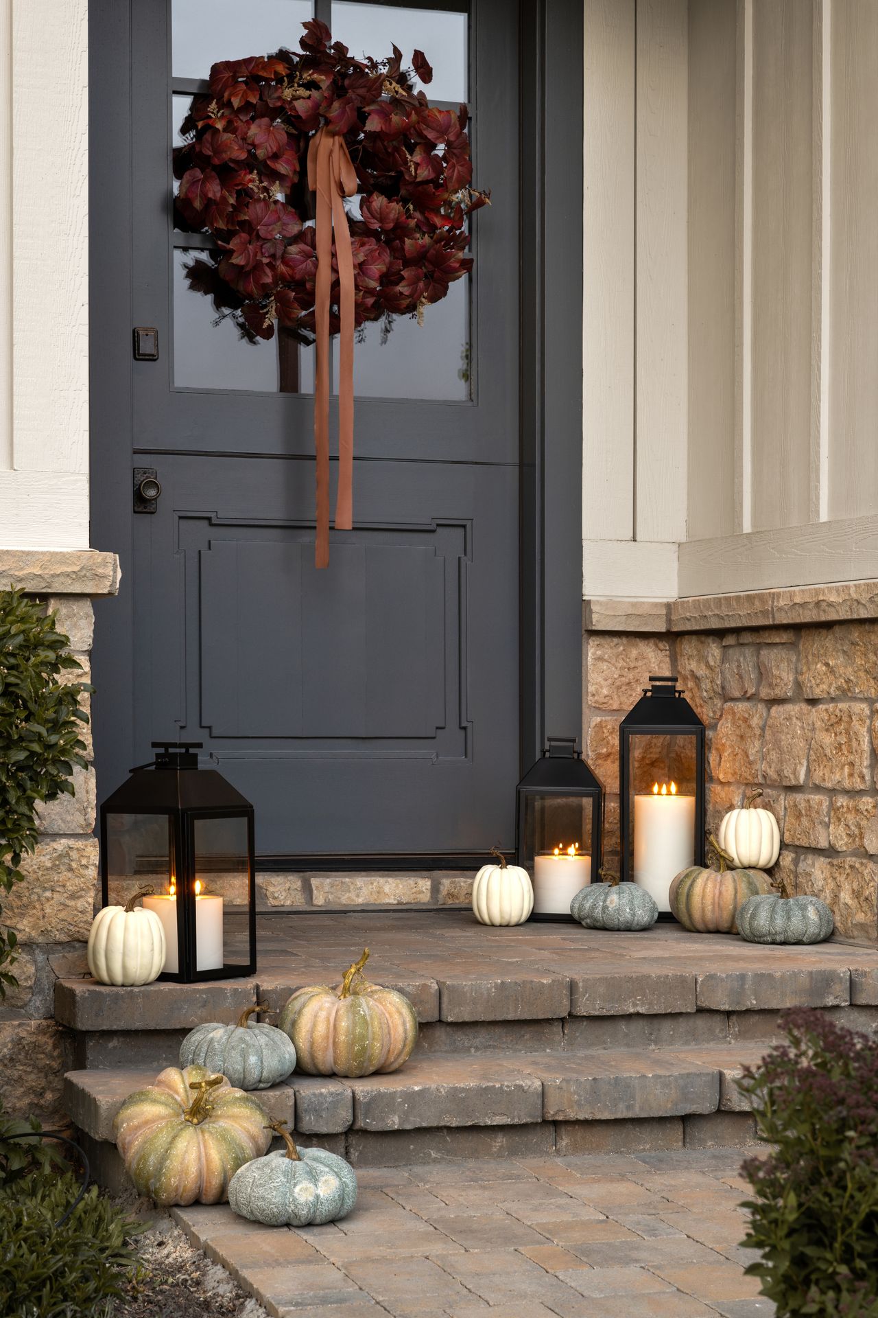 A front porch with small lanterns