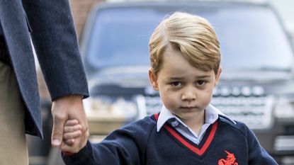 Prince George holding his parents hands