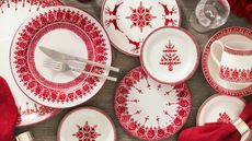 Red and white fair isle dinnerware with red napkins and silver napkin rings