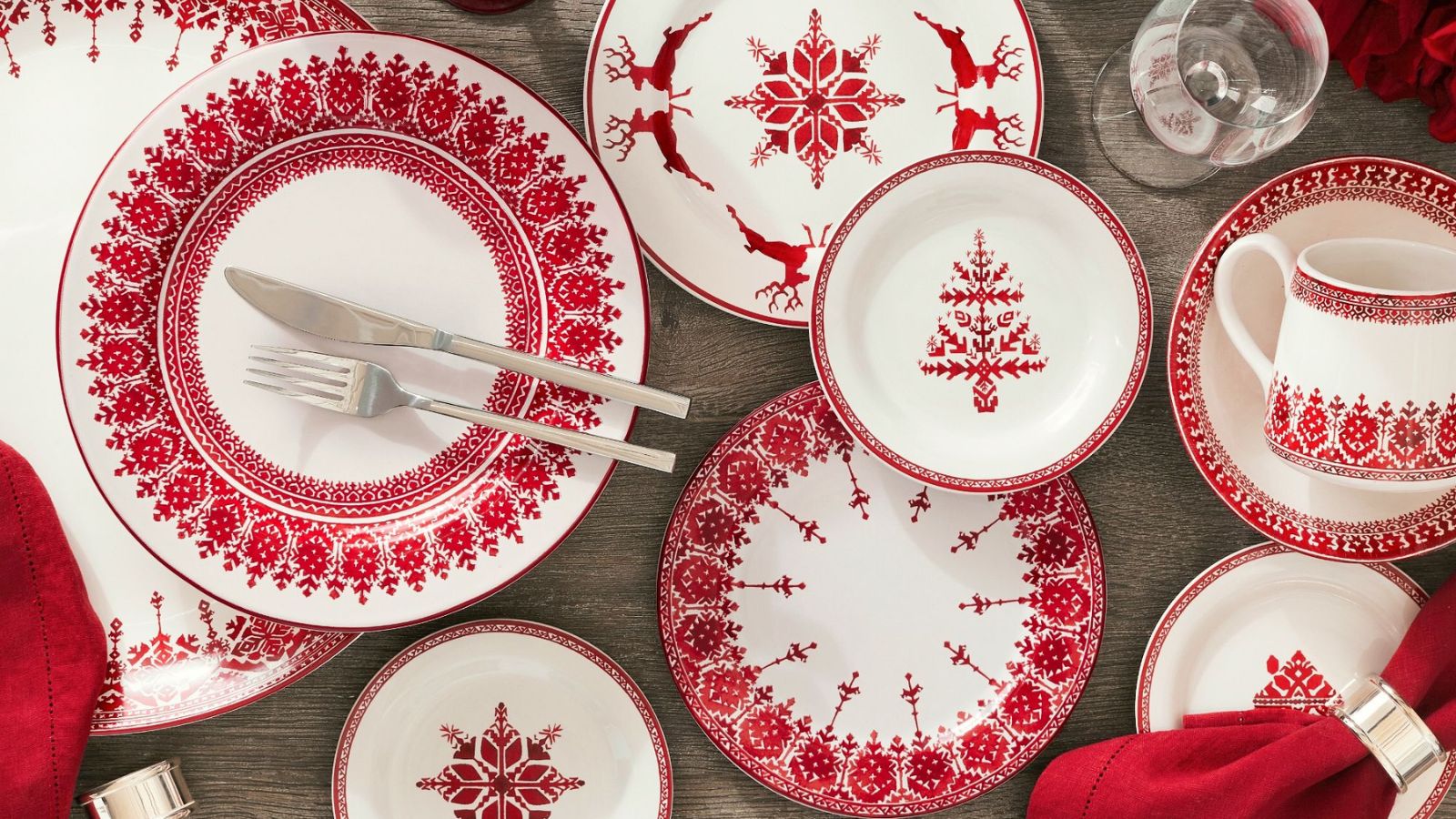 Red and white fair isle dinnerware with red napkins and silver napkin rings
