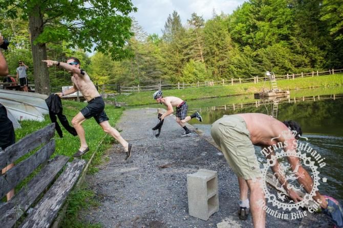Three riders run to dip their sweatshirts
