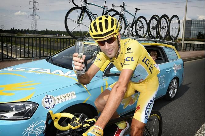 Astana's Vincenzo Nibali enjoys a glass of champagne during stage 21 to Paris