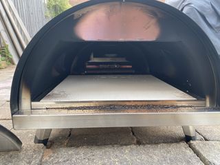 Woody pizza oven covered in soot