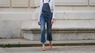 woman wearing dungarees and orange heels