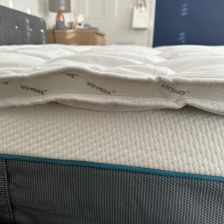 A side view of the Silentnight Airmax mattress topper on a mattress
