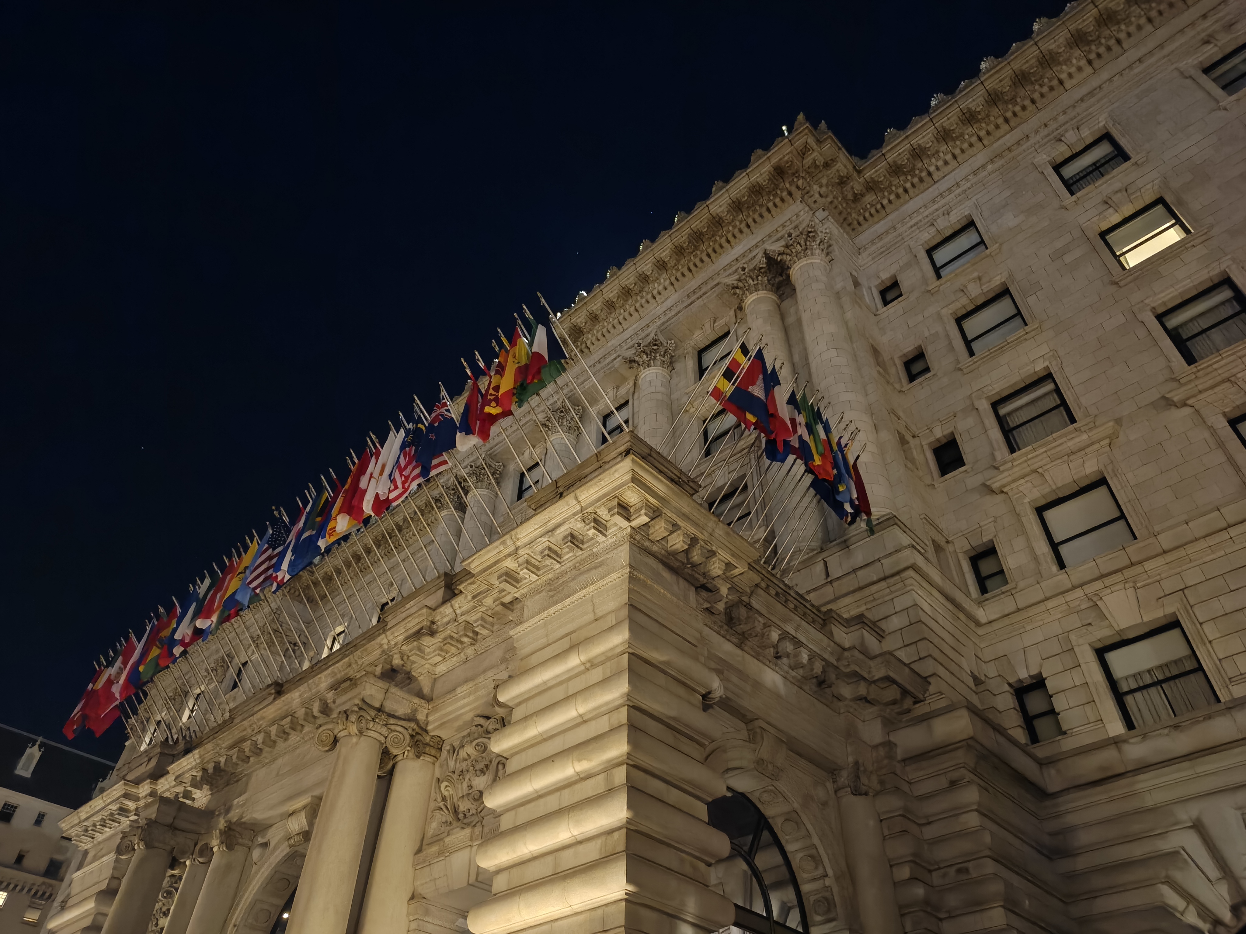 A building at night with flags