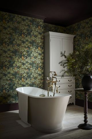 a bathroom with wallpaper and a burgundy ceiling