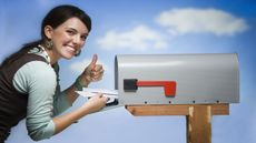 picture of happy woman getting mail from mailbox