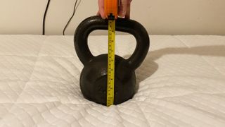 A weight and tape measure on the Nectar Essential Hybrid Mattress