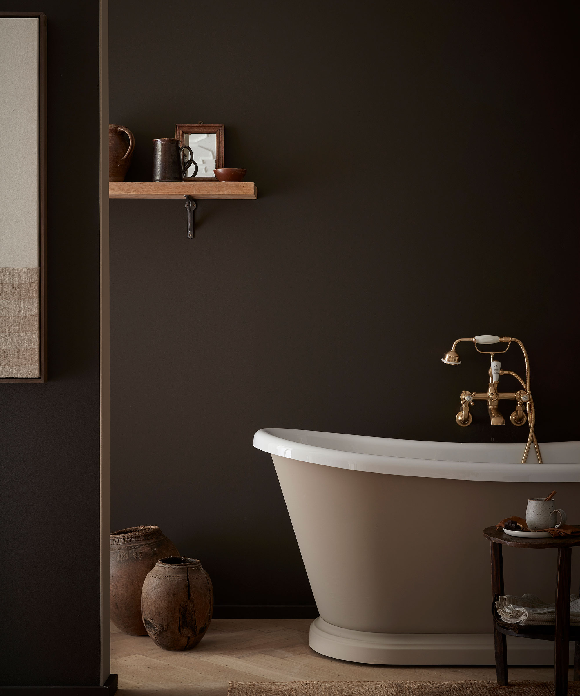 small bathroom with brown paint on walls and light brown paint on bath