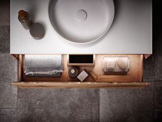 White sink and countertop, wooden draw with lighting
