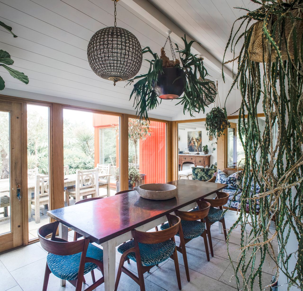 A garden room with houseplants and reclaimed interiors