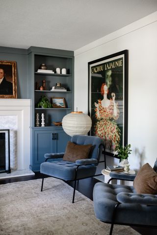 A living room with blue painted on the built-ins