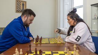 Alex Brooker takes on Scarlett Moffatt in a game of chess.
