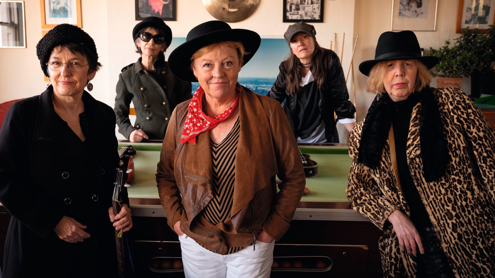 Members of the band Ukadelix pose around a pool table