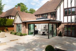 Clear modern sliding doors on period extension