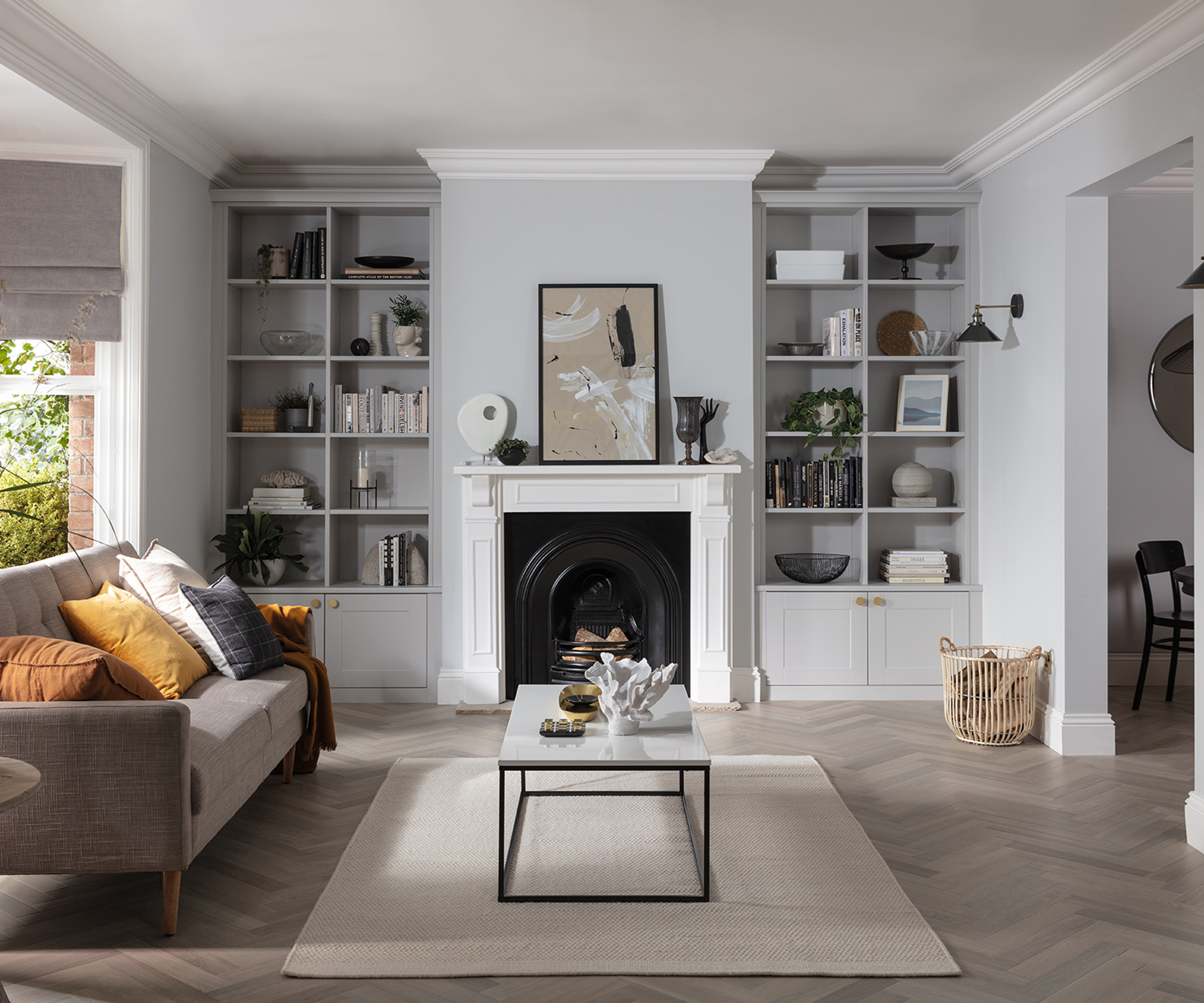 living room with white fireplace and shelving units either side of the fireplace