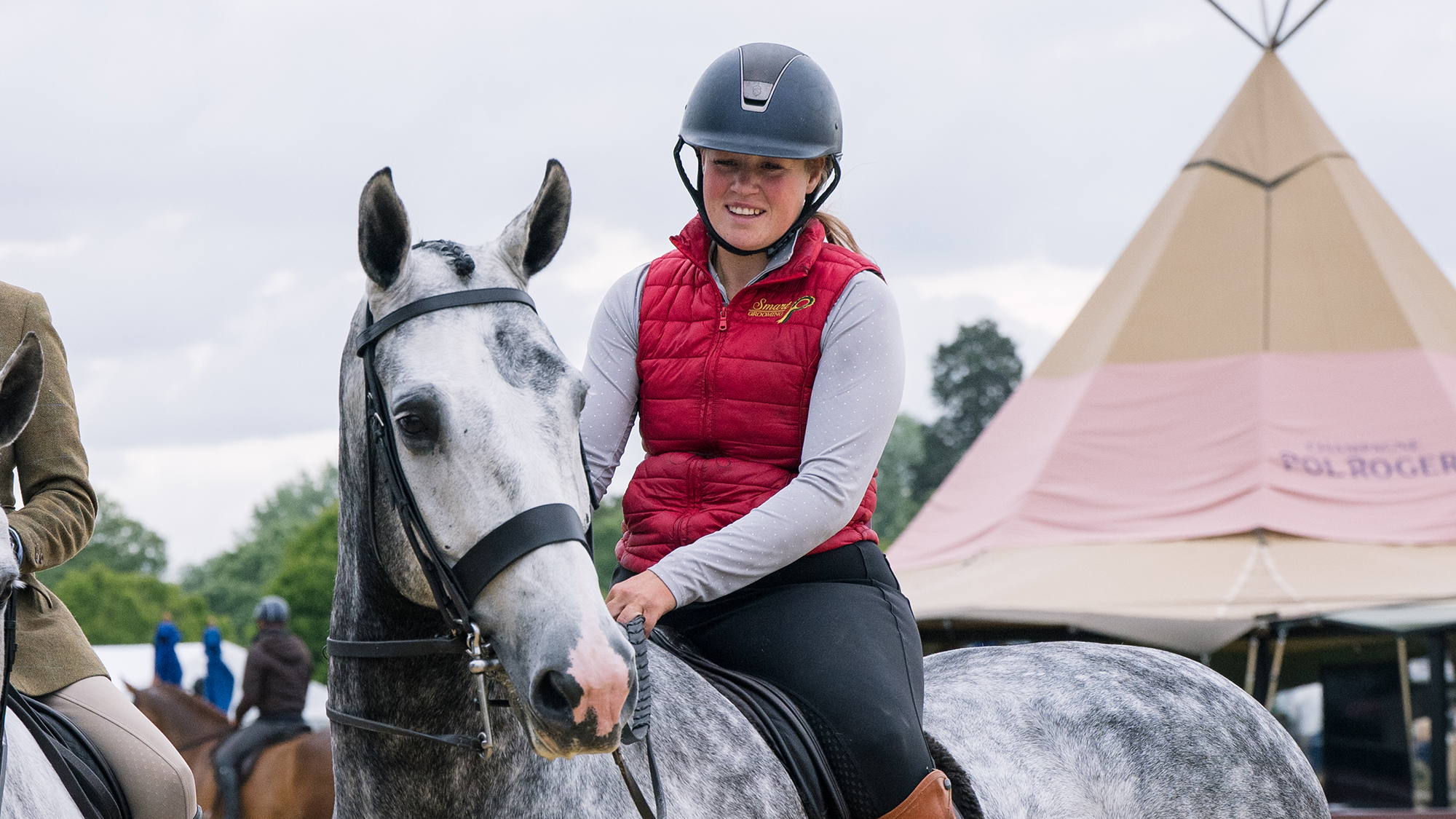 Show horse groom Ellie Greenhalgh rides a large grey hunter