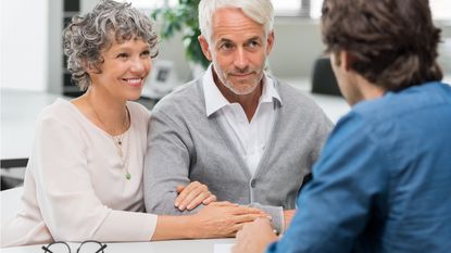 An older couple talks with a financial planner.