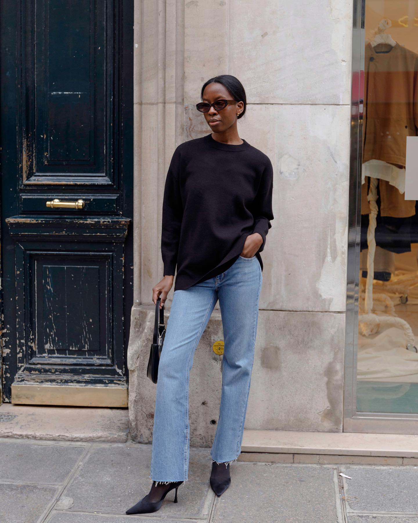 @sylviemus_ wears light blue frayed hem bootcut jeans with pointed-toe mules.