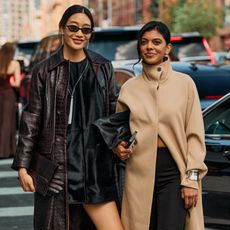 New York Fashion Week street style of two attendees wearing chic outerwear like a funnel neck coat and and croc-embossed jacket coat