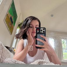 Selena Gomez taking a mirror selfie.