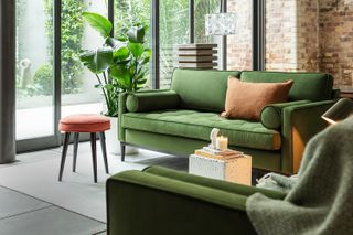 Swyft green sofa in an exposed brick living space