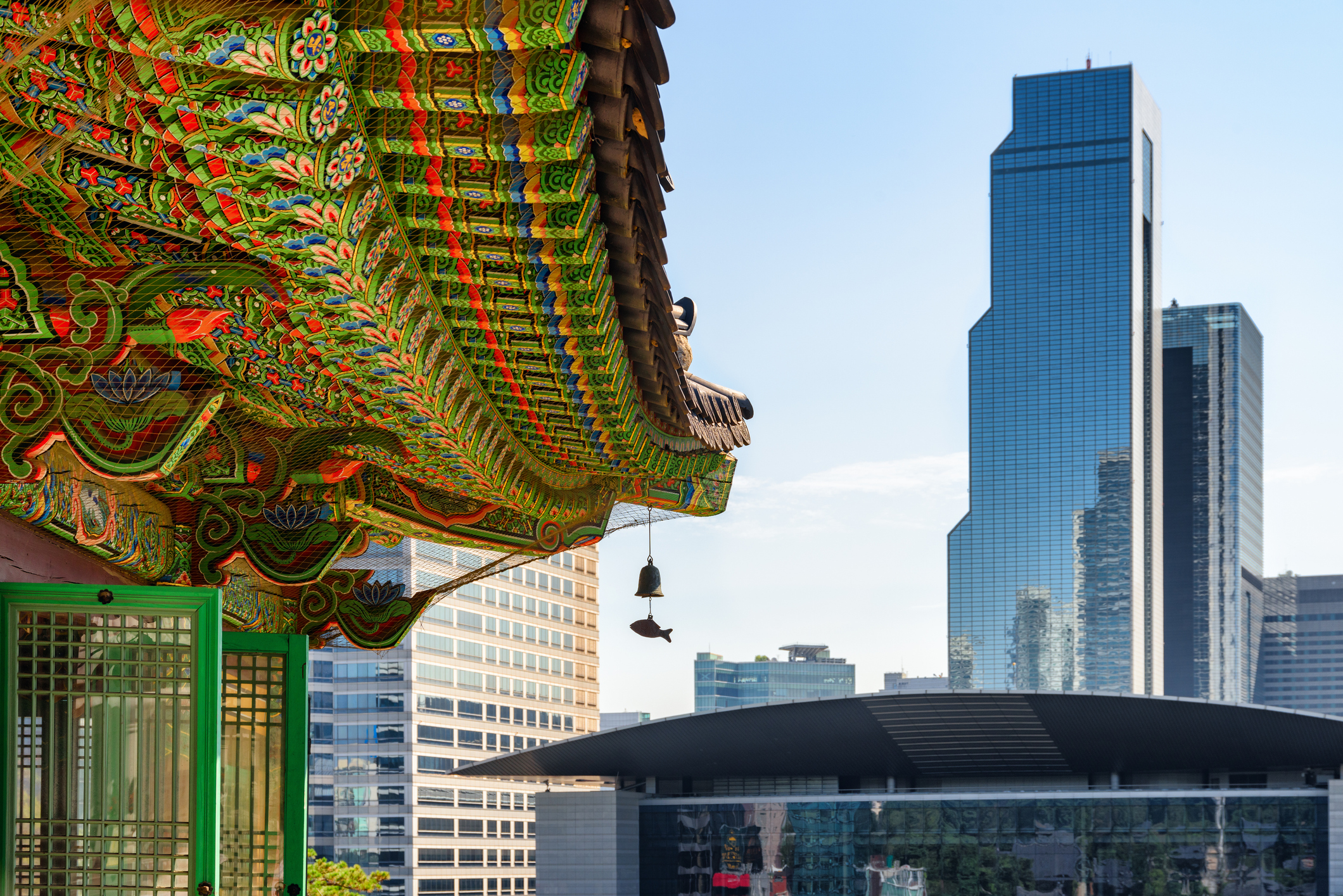 colorful roof of Bongeunsa Temple and skyscrapers at Gangnam District in Seoul, South Korea