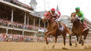 Rich Strike (L) with Sonny Leon up and Mo Donegal (R) with Iran Ortiz Jr. up head toward the first turn during the 148th running of the Kentucky Derby at Churchill Downs on May 07, 2022 in Louisville, Kentucky.