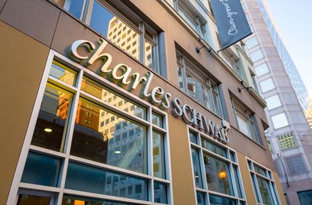 Low-angle view of logo on facade of Charles Schwab brokerage in the Financial District neighborhood of San Francisco, California, December 25, 2018.