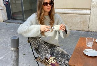 Woman in leopard pants and sweater