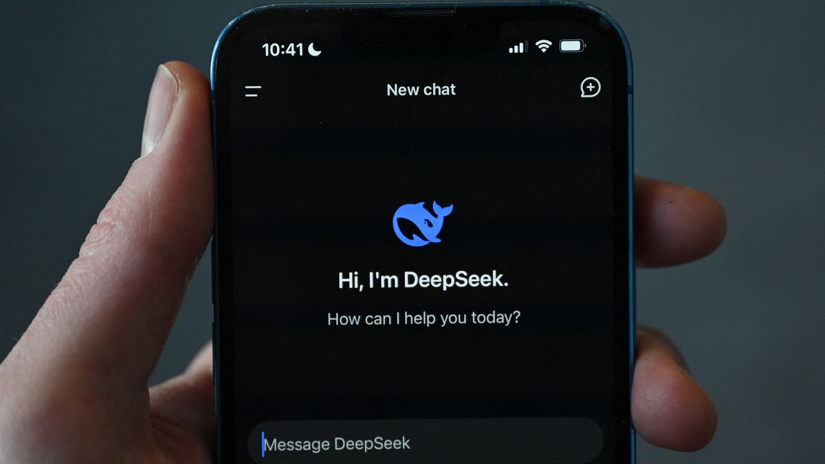 A hand holds a smartphone with the DeepSeek AI chatbot on the screen