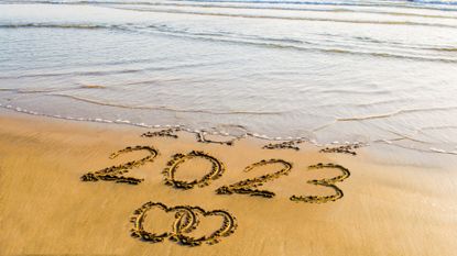 New Year 2023 text on sea beach with love concepts.