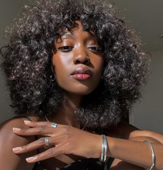 Emmanuelle Koffi with a curly bob