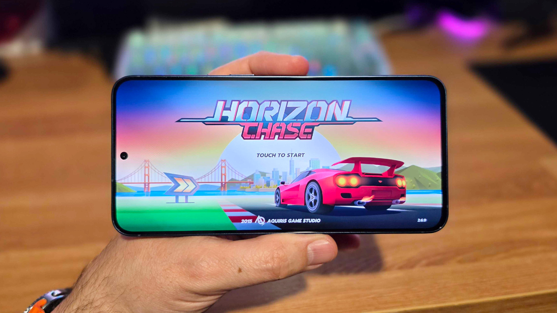 Samsung Galaxy A57 in-hand showing Horizon Chase game