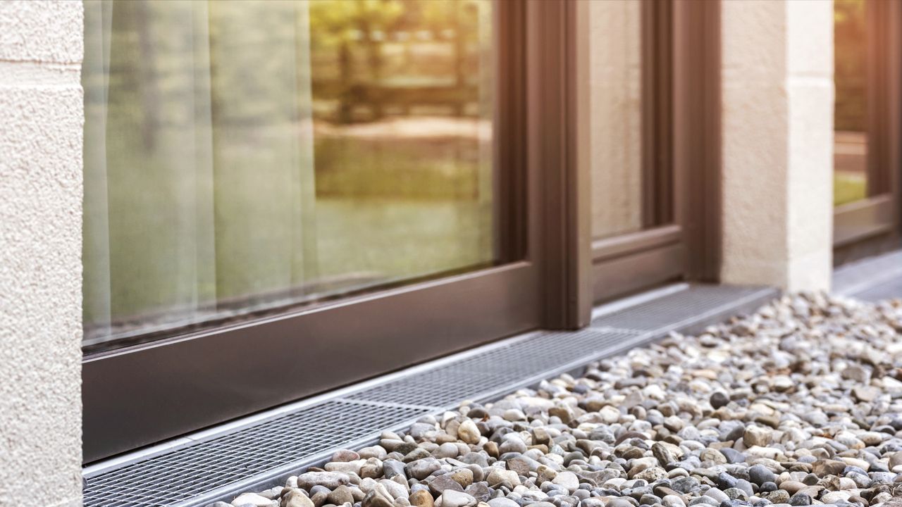 Drainage channel with gravel at the rear of a house