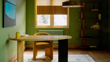 Green home office with wood desk with black leg, abstract white rug, yellow blinds and black and blue abstract artwork