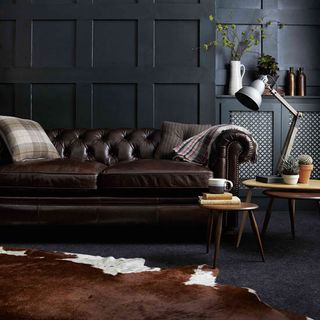 living room with leather sofa and dark carpet floorig