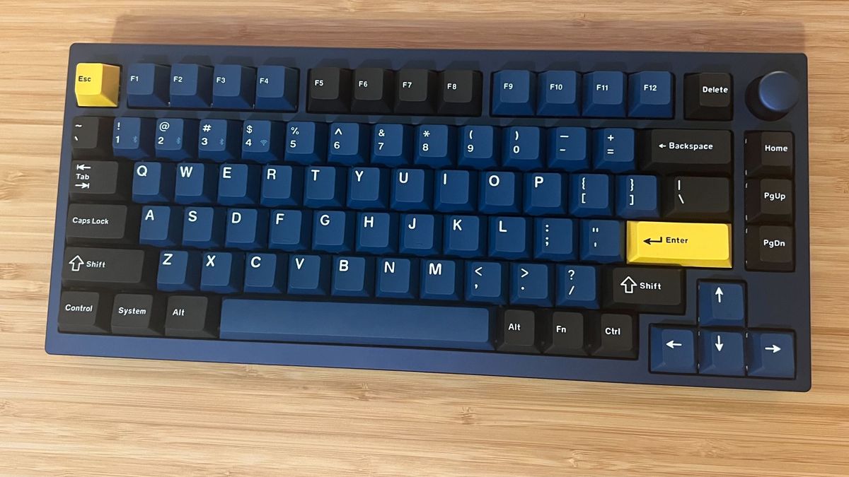 Lemokey P1 Pro blue and yellow gaming keyboard on a wooden desk