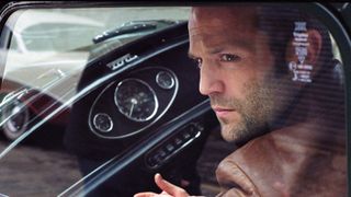 Jason Statham sits in a car in The Bank Job (2008)