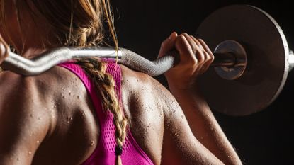 Chest and back workout: Woman lifting weights